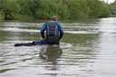 picture of owner sending newfoundland dog to retrieve life ring