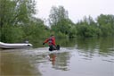 picture of owner sending black newfoundland dog out to steward to be rescued